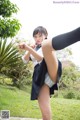 A woman in a school uniform is posing for the camera.