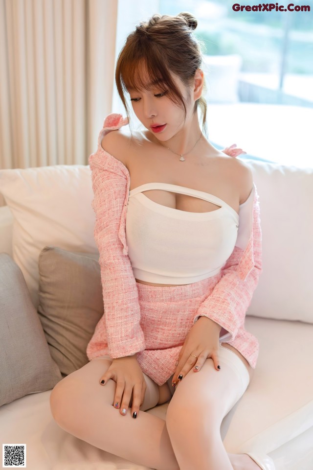 a woman sitting on top of a white couch